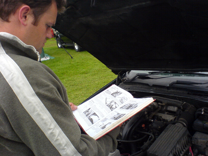 Monster learning how to be a car mechanic