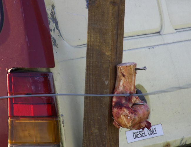 Raw meat being cut by a winch cable