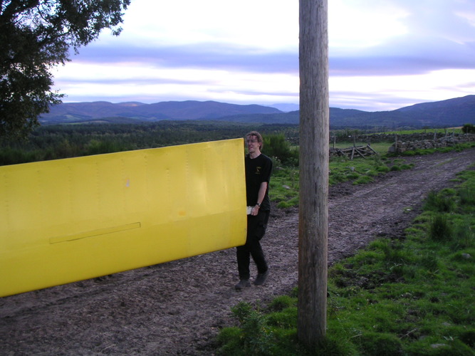 Martin carrying Snoopy's wing out of his field