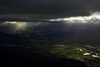 Shafts of sunlight behind showers